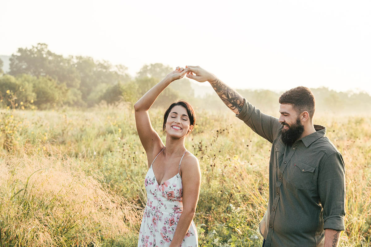 engaged couple dancing tall grassy field commons ford park engagement photography