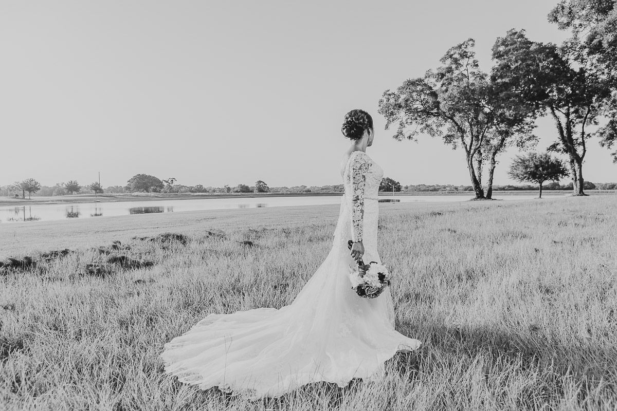 bride standing near lake eberly ranch texas black and white