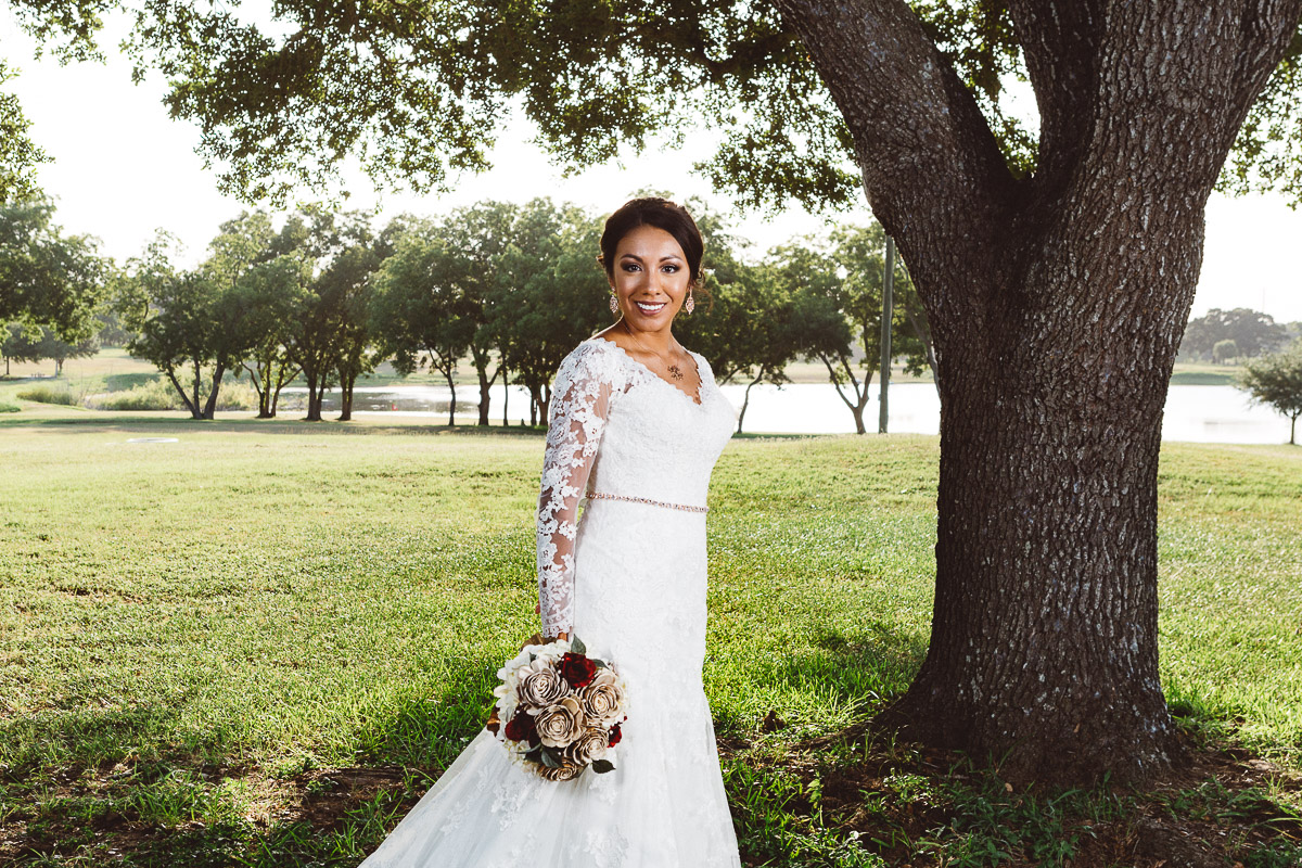 bride under tree with lake background eberly ranch texas